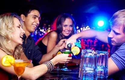 people enjoying drinks at the bar